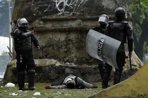 La policía antidisturbios junto a un manifestante herido durante los enfrentamientos en Quito el 24 de junio de 2022, en el marco de las protestas lideradas por indígenas contra el gobierno.